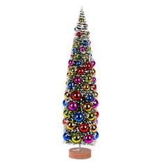 a multicolored christmas tree with ornaments on it's base and a white background