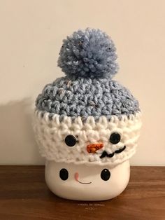 a crocheted hat with a snowman face on it