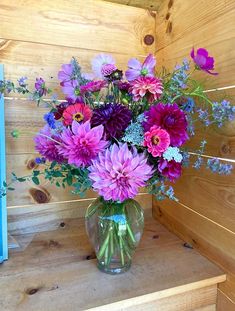 a vase filled with lots of purple flowers