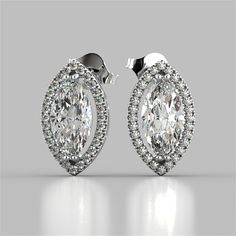 Dress up your attire with this posh set of earrings. Vibrant center stones are featured within a stunning simulated diamond pave halo. An optimal choice for your ensemble.    Marquise Cut Drop Style Stud Earrings;  Center Stone: 2CT Each;  Total Carat Weight: 4.42CTW;  Stone Clarity: VVS-1;  Available in: 14K White Gold;  Model:ER2508-WH; Diamond Stud Earring, Diamond Earrings Studs Round, White Gold Earrings Studs, White Gold Studs, Round Halo, Gold Models, Halo Earrings Studs, Marquise Cut Diamond, Round Diamond Engagement Rings