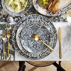 a table topped with plates and silverware