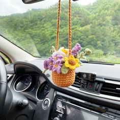 a car dashboard with a flower basket hanging from the dash board