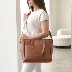 This structured tote is the ultimate do-it-all bag that you deserve. It's the perfect carryall for work, travel, and anywhere your day brings you. It features a spacious and organized interior for your essentials, a padded compartment for your laptop, side pockets for your drinks, and you can convert it into a backpack or crossbody. Crafted from premium American Saffiano leather that's waterproof and scratch-resistant, the Transform Tote will stay just as beautiful through all your travels and a Rectangular Cognac Travel Bag For Everyday Use, Cognac Rectangular Travel Bag For Everyday Use, Cognac Tote Travel Bag For Everyday Use, Cognac Travel Bag For Everyday Use, Everyday Cognac Tote Travel Bag, Everyday Cognac Rectangular Travel Bag, Modern Office Tote Travel Bag, Everyday Travel Bag With Leather Handles In Cognac, Modern Weekender Bag With Removable Pouch For On-the-go