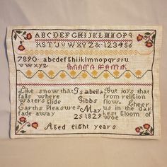 an embroidered sample of the alphabet and numbers