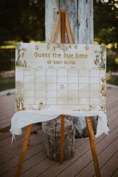 an easel with a sign that says guess the due date of baby quivia