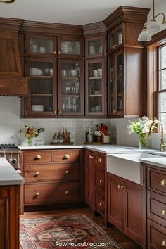 a kitchen with wooden cabinets and white counter tops, along with a rug on the floor