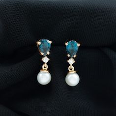 Product Details These Drop Earrings are perfectly adorned with Freshwater Pearl as Drop and Pear Cut London Blue Topaz with Moissanite. Freshwater Pearl - Freshwater Pearl exhibits AAA Quality and possess subtle color. Semi Precious June Birthstone summons faith and innocence. It is Natural and Certified, helps in enhancing personal integrity and grow sincerity of the wearer. The extremely durable nature and luster makes it a captivating and desirable gem. London Blue Topaz - Brilliant Cut Londo Personal Integrity, Signature Jewelry, June Birthstone, Timeless Jewelry, London Blue Topaz, June Birth Stone, Topaz Gemstone, London Blue, Silver Earrings Dangle