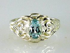 ALL OUR JEWELRY IS HANDCRAFTED IN THE U.S.A. One simple and lovely Natural earth Mined Aquamarine graces this classically designed filigree ring. This is a wonderfully comfortable ring that is very feminine. Made of solid .925 sterling silver. You'll wear this one for any occasion!! Aquamarine, (1) 7x5mm Oval, 0.75 Oval Topaz Ring Stamped 925 For Anniversary, Oval Silver Hallmarked Topaz Ring, Silver Oval Topaz Collectible Ring, Collectible Oval Topaz Ring In Sterling Silver, Oval Aquamarine Ring, Aquamarine Solitaire Ring, Aquamarine Engagement Ring, Three Rings, Aquamarine Ring