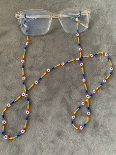 It's made with glass beads. I sell these at local gifts shops. I can make them at any color you wish. Thank you for looking. Beaded Clear Glasses Chains As Gift, Handmade Clear Beaded Necklaces As Gift, Gift Beaded Clear Glasses Chains, Beaded Clear Glasses Chains Perfect For Gifts, Clear Glass Beaded Necklace, Daisy Glasses, Bracelet Pearls, Beaded Daisy, Beaded Braclets