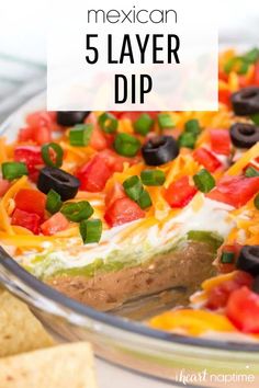 mexican 5 layer dip in a bowl with tortilla chips