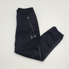 -Black Athletic Pants From Under Armour In Size 4 -Jogger Cuff -Zippered Pockets With Logo Detailing -Brand New With Tags From A Smoke-Free, Pet-Free Home Happy To Answer Any Additional Questions. Check Out My Closet For More Great Listings And Bundle For An Automatic Discount! Black Athletic Pants, Athletic Pants, Kids Bottoms, Under Armour, Sweatpants, Size 4, Cuff, Pet, Tags