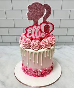 a birthday cake with pink frosting and glitter decorations