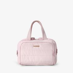 a pink handbag sitting on top of a white surface