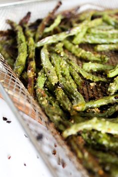 grilled green beans in a glass dish on a table