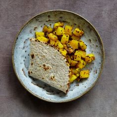 a white plate topped with a tortilla and sliced up pineapple