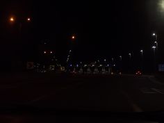 an empty road at night with street lights