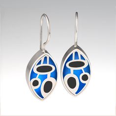 Resin & Silver Earrings - These luminous earrings are made with a unique layering process combining sterling silver, resin, pigments and mica. Fun yet classic, these earrings pop with any outfit.<br><br>1.5 by 0.5w. Sterling silver ear wires. Blue Polished Drop Earrings, Blue Drop Earrings With Polished Finish, Modern Enamel Earrings For Formal Occasions, Modern Formal Enamel Earrings, Modern Oval Blue Earrings, Modern Blue Oval Earrings, Modern Enamel Jewelry With Pierced Details, Modern Silver Earrings With Black Enamel, Black Enamel Teardrop Earrings For Gift