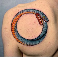 a man with a snake tattoo on his shoulder