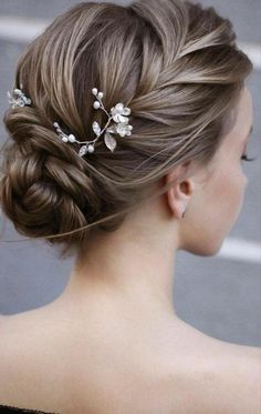 a woman wearing a hair comb with flowers in it