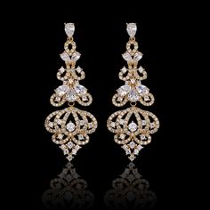 Our Lush Chandelier Earrings are a gorgeous accessory. They're long, detailed with crystal dangles to resemble the ornate finial of a chandelier. Pair these striking earrings with a date night dress and watch heads turn as you walk into the room. Premium Materials - Made from authentic gemstones & nickel-free metal Jewellery Sketch, Antique Luxury, Chandelier Earring, Diamond Chandelier Earrings, Diamond Chandelier, Bridal Earrings Chandelier, Gold Chandelier Earrings, Date Night Dress, Gold Mangalsutra Designs