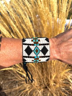 Make a statement with this hand loomed beaded cuff. Our newest cuff, Buffalo Fringe, is loaded with gemstones and super fun to wear. * onyx * natural turquoise * amber * pearls For the best fit, measure your wrist above the bone towards your heart, and select the appropriate size at checkout. The closure on this cuff (buffalo nickel and deer skin lace) will give in and you will be able to adjust to your own liking/comfort. Leather will give in over time and look even more remarkable! Artisan Beaded Turquoise Cuff Bracelet, Handmade Western Style Cuff Bracelet, Artisan Turquoise Beaded Cuff Bracelet, Handmade Western Cuff Bracelet, Southwestern Beaded Bangle Bracelet, Southwestern Turquoise Cuff Bracelet With Inlay, Southwestern Style Hand-strung Beaded Bracelet, Raw Turquoise, Turquoise Leather