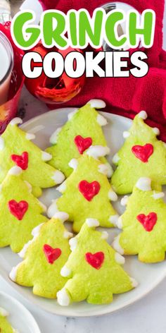 green christmas tree cookies on a white plate with red heart decorations and text overlay