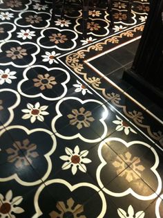 a black and white tiled floor with flowers on it