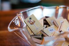 a glass bowl filled with lots of small cards