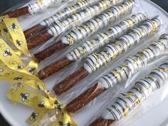 there are many different types of candy wrapped in plastic wrappers on the plate and tied with yellow ribbon