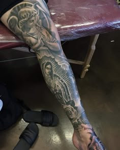 a man's leg with tattoos on it