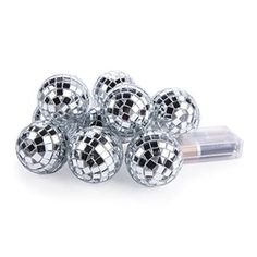 silver disco balls are stacked on top of each other in front of a white background