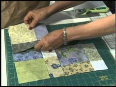 two people are cutting up fabric on a table