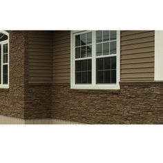 a brown house with white trim and windows