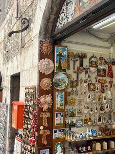 an outdoor shop with souvenirs and magnets on the wall