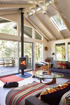 a living room filled with furniture and a fire place in the middle of it's walls