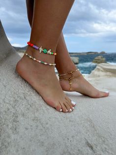 Add a touch of unique style to your summer wardrobe with these stunning handmade ankle bracelets! The first one boasts a colorful array of beads in different shapes, accented by white coral beads, gold metal parts, and a round evil eye charm in green color for added protection and good luck. The second bracelet features luminous white freshwater pearls, alongside vibrant colorful beads and gold metal parts, for an elegant yet playful look. Both bracelets are fully adjustable to fit any ankle siz Colorful Beads Anklet For Summer Gift, Colorful Beaded Bracelets For Summer Beach, Colorful Beaded Anklets For Summer Gifts, Colorful Beads Anklet As Summer Gift, Trendy Beach Anklets With Tiny Beads, Colorful Beads Anklets For Summer Vacation, Colorful Beads Bracelet For Summer Beach, Colorful Beaded Anklets For Summer, Colorful Beaded Anklets For Summer Vacation