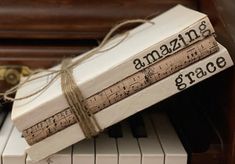 three books tied with twine on top of a piano keyboard, which is decorated with music notes