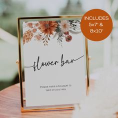 a flower bar sign sitting on top of a wooden table