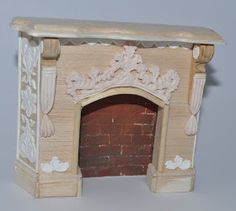 an old fireplace is painted white and has carvings on the mantle, along with a brick fire place