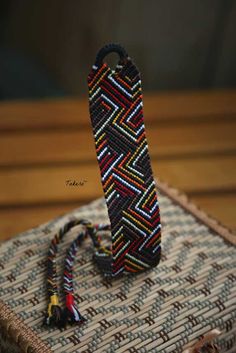 a beaded bracelet sitting on top of a table