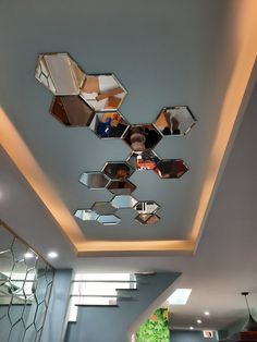 the ceiling has many mirrors on it and is decorated with modern art deco style elements