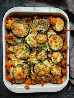 a casserole dish filled with eggplant and cheese