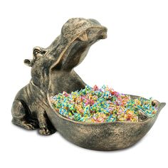 a rhinoceros eating out of a bowl filled with sprinkles