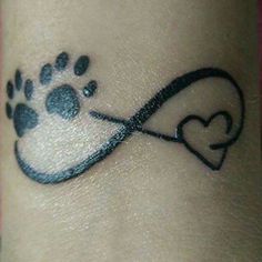 a dog paw and heart tattoo on the wrist