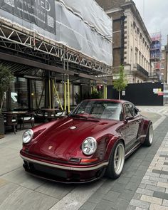 a red car parked on the side of a street