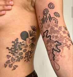 two people with tattoos on their arms