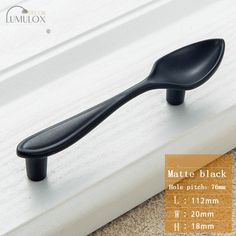 an image of a black door handle on the outside of a window sill with measurements