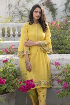 Yellow kurta with pleats at the yoke, floral embroidery at the cuffs and hem. Comes with pant and inner slip.
Component: 3
Embroidered
Neckline: Round
Sleeve Length: Three Quarter
Fabric: Kurta: Chanderi Pant and Inner Slip: Cotton
Color: Yellow
Flared sleeves
Keyhole at the back
Asymmetric hem
Embroidered straight fit pant - Aza Fashions Yellow Kurta, Straight Fit Pants, Embroidered Neckline, Cotton Embroidery, Fashion App, Pant Set, Cotton Pants, Set For Women, Festival Wear