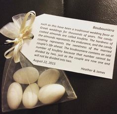 some white eggs in a clear bag with a ribbon on the side and a note attached to it