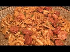 a plate full of pasta with sausage and sauce